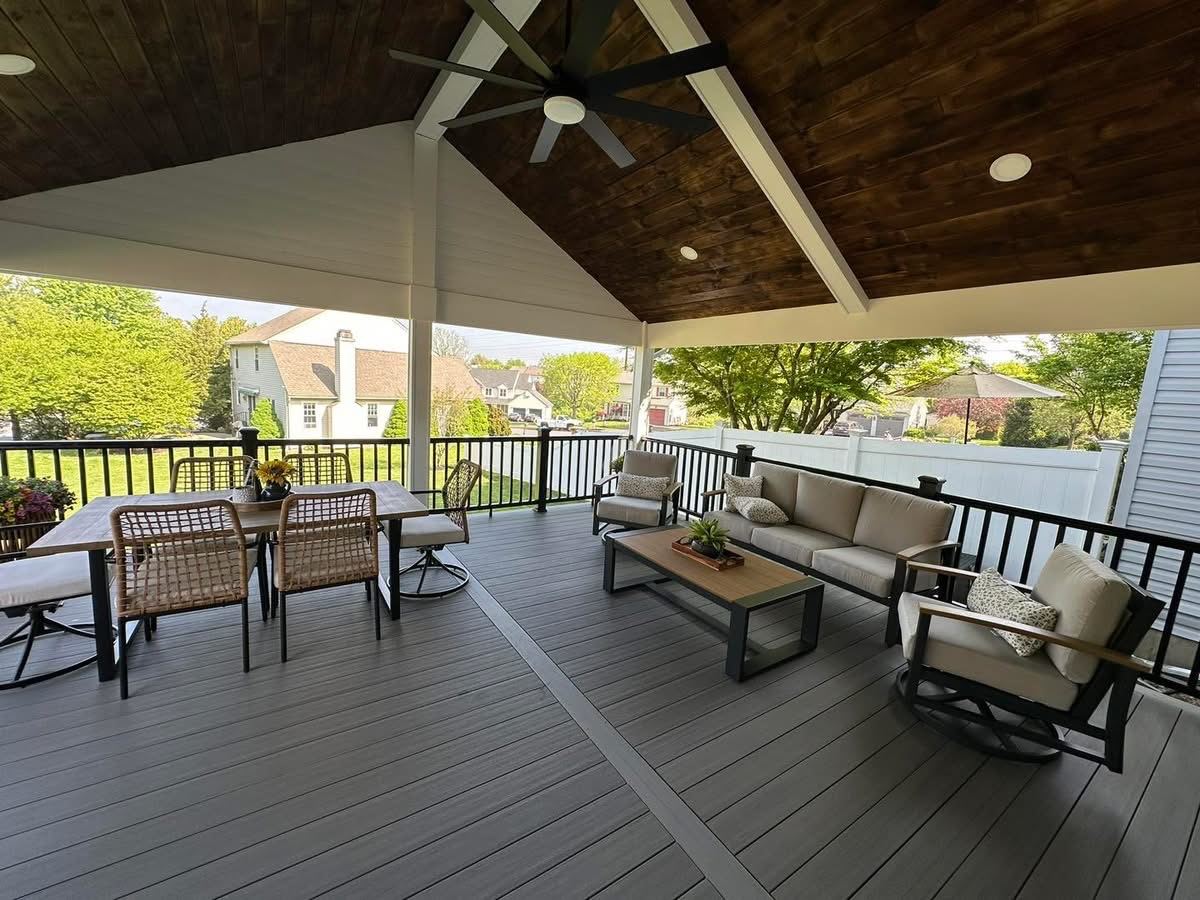 Covered composite deck with a vaulted wood ceiling and outdoor seating