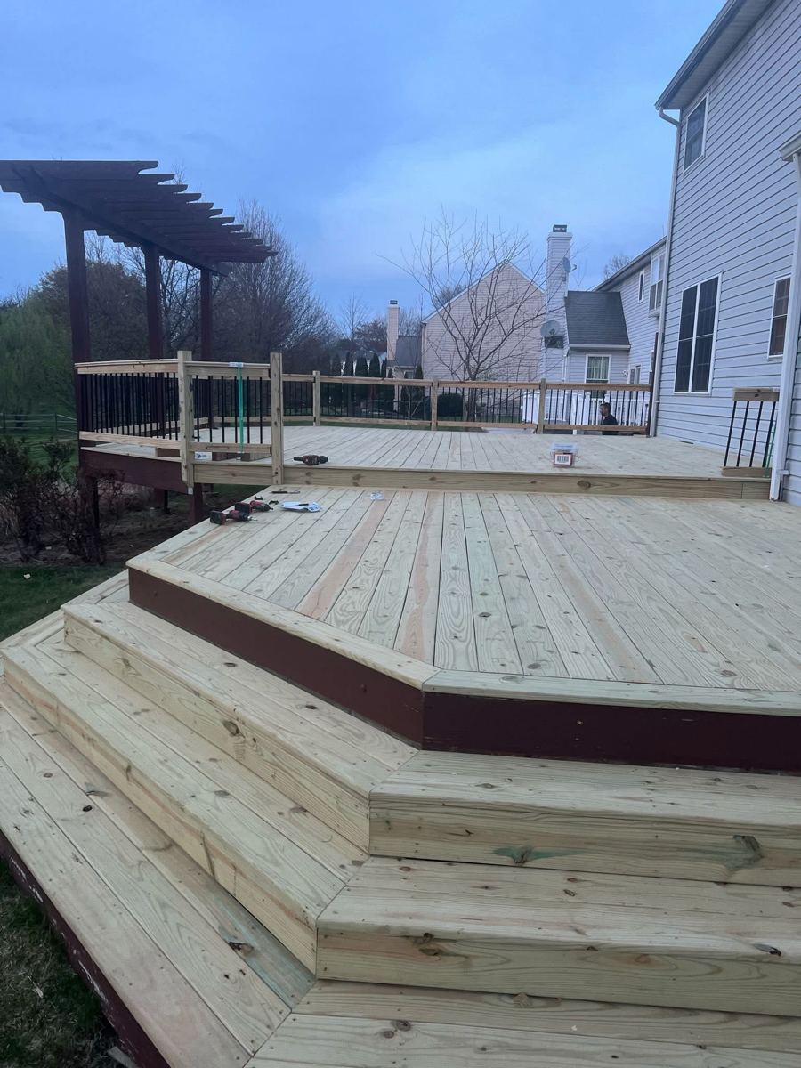 Multi-level pressure-treated wood deck with wide steps