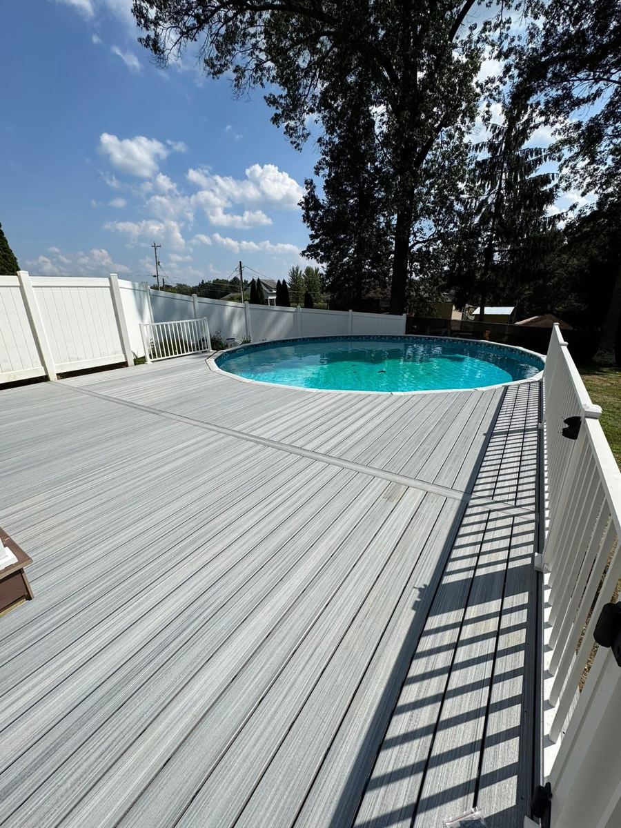 Composite deck surrounding an above-ground pool